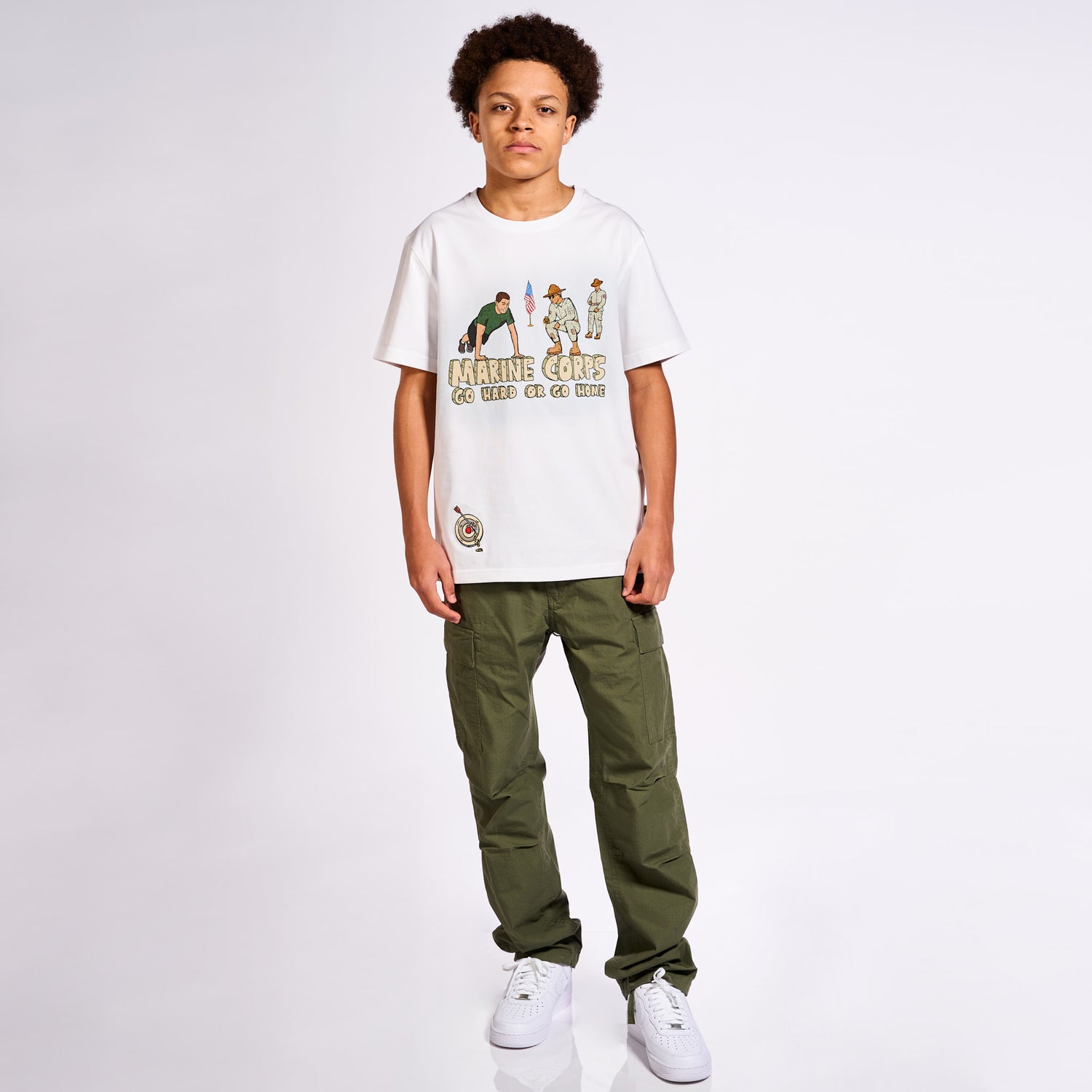 A model wearing Allmosst Marine Corps Graphic T-shirt with Olive Cargo pant on with background 