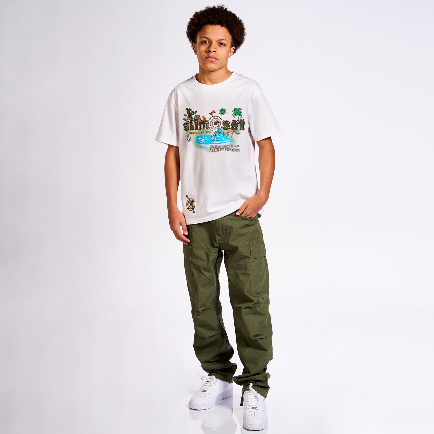 Model wearing Allmosst State of Mind Graphic T-shirt, Olive Cargo pant and white Sneaker 