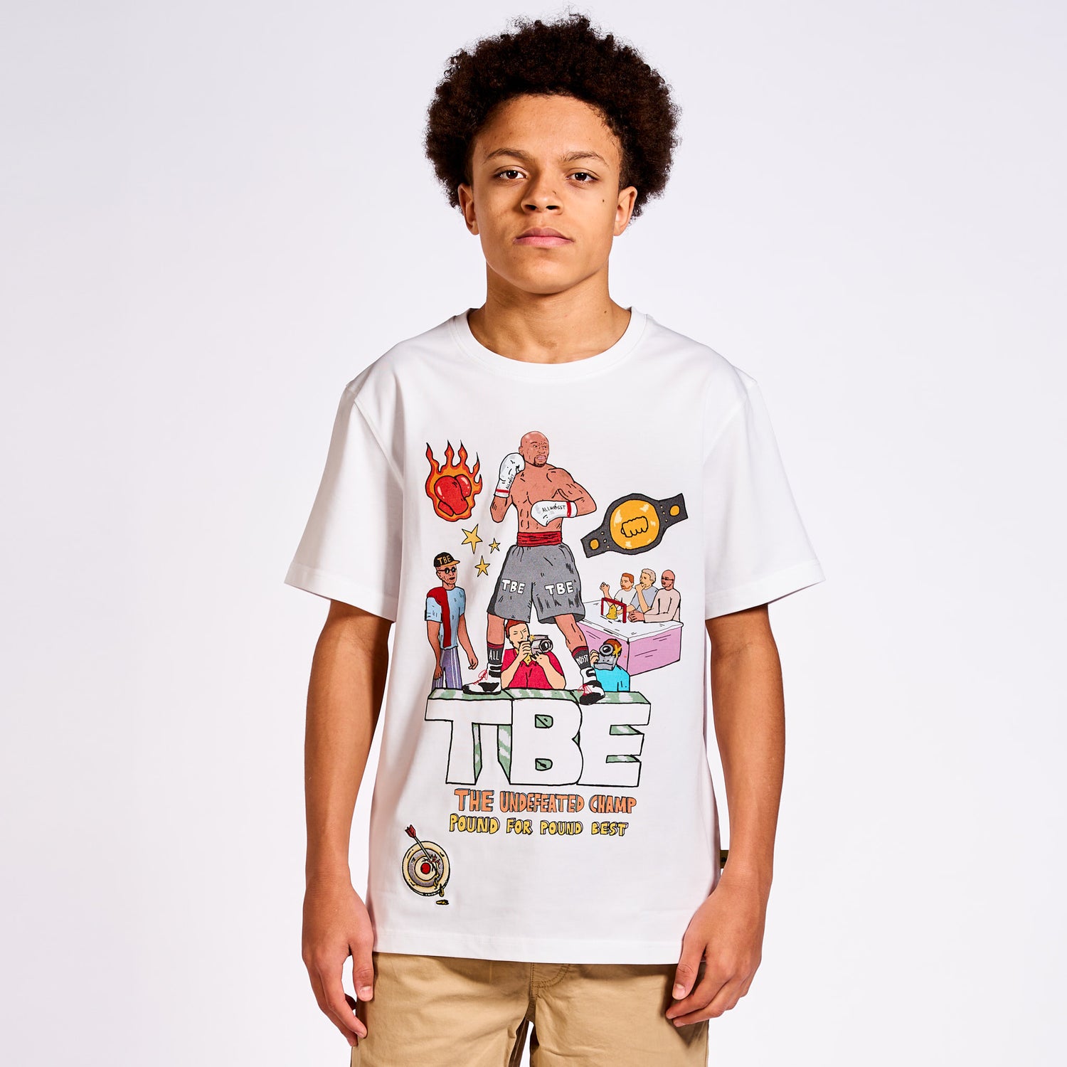 Model wearing Allmosst white t-shirt with colorful graphics and text on a plain background