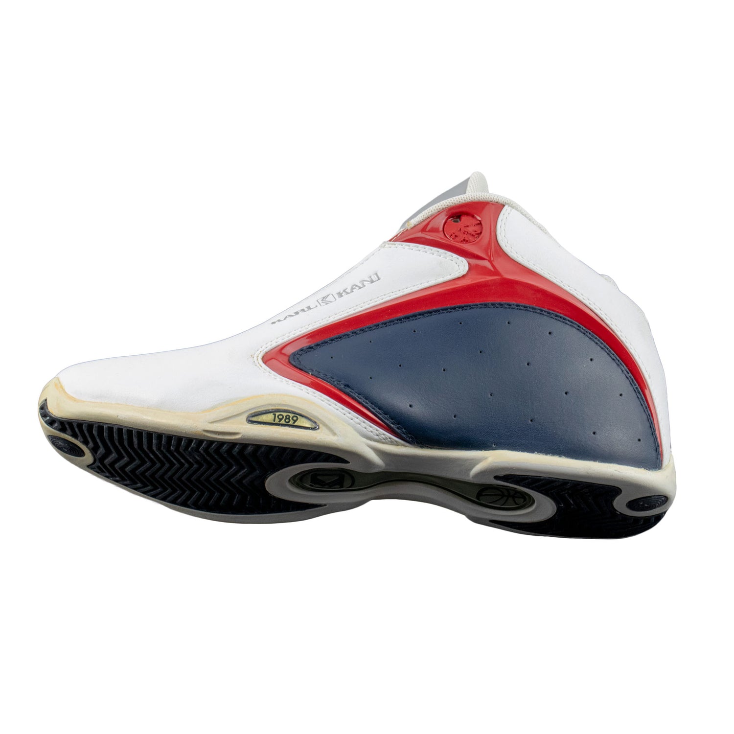 White, red, and blue athletic shoe on a white background