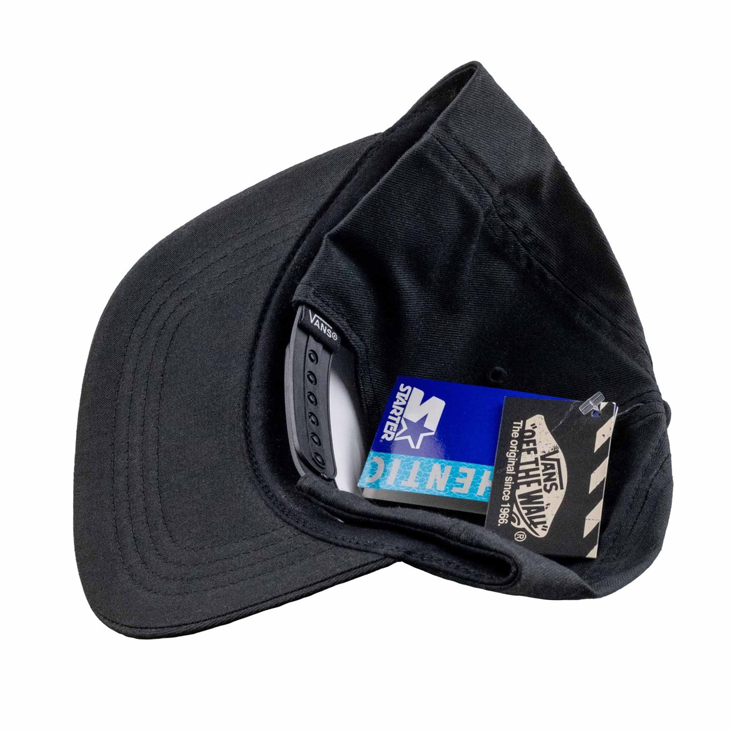 Black cap with a visible brand tag on a white background