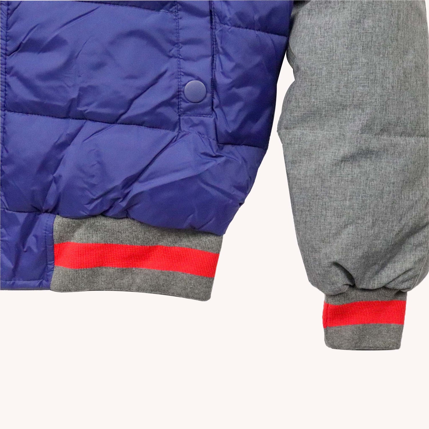 Close-up of a blue and gray jacket with red accents on a white background