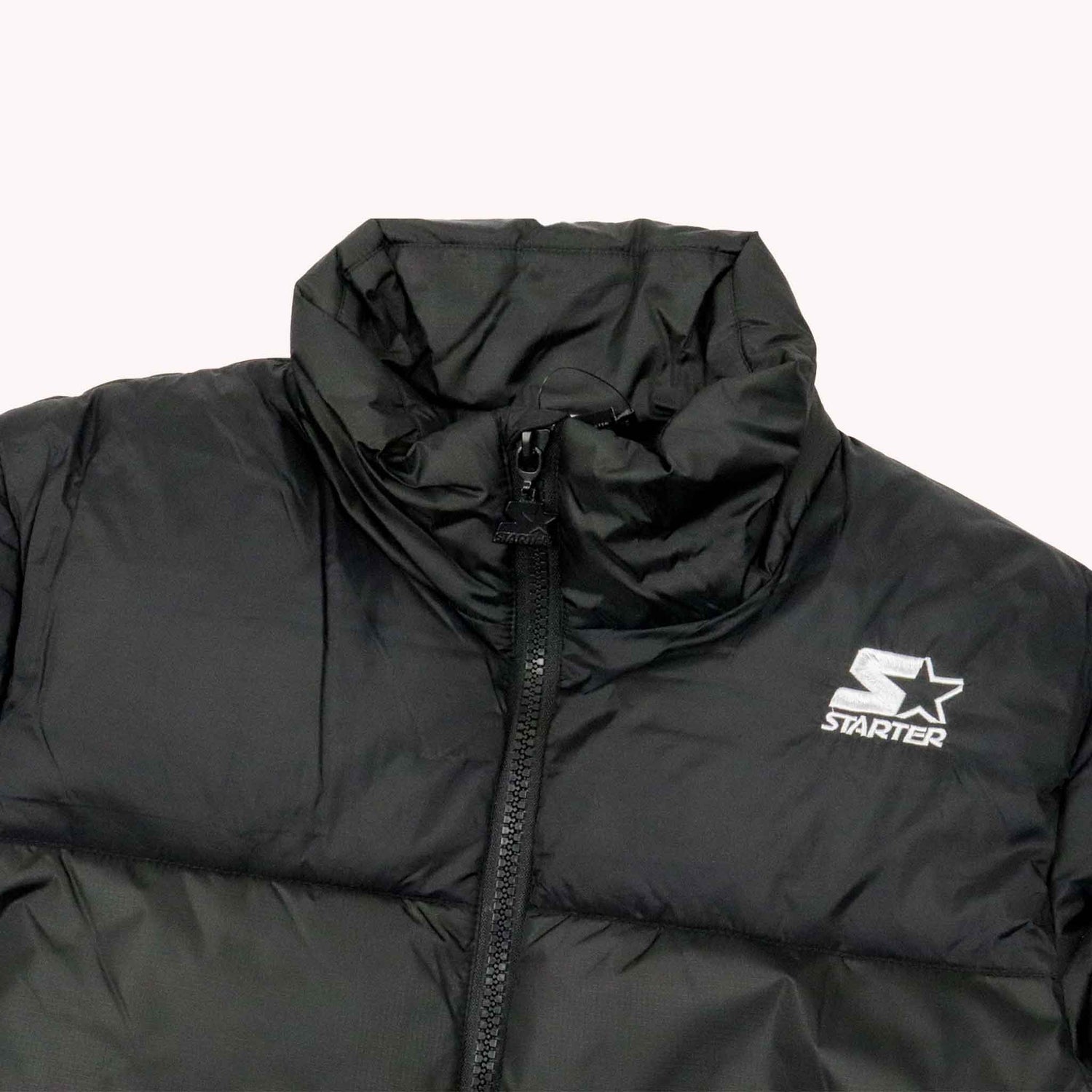 Black puffer jacket with Starter logo on a white background