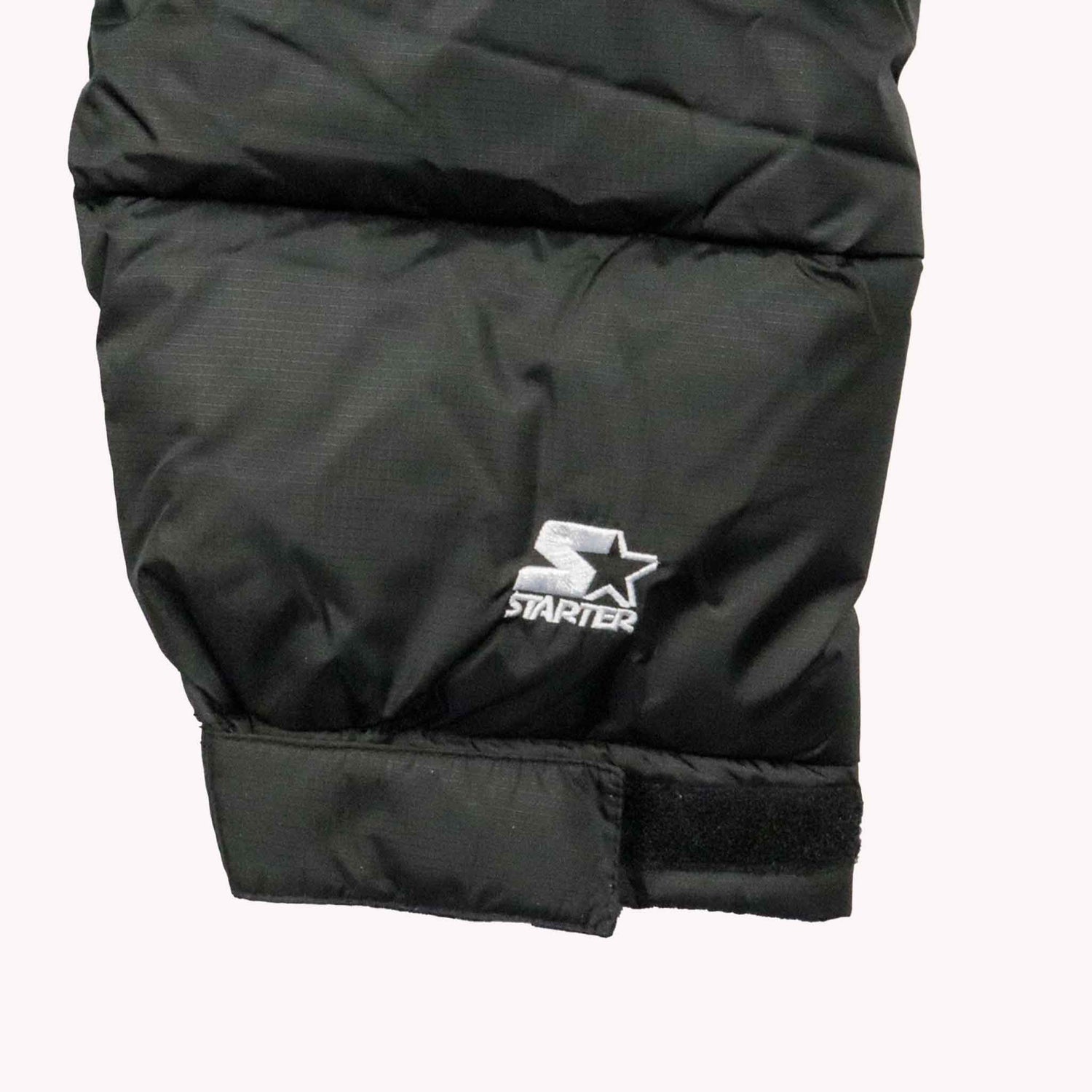Black puffer jacket with Starter logo on a white background