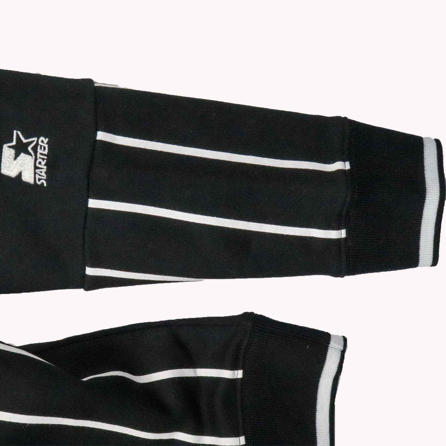 Black arm sleeves with white stripes and a visible 'Starter' logo on a white background