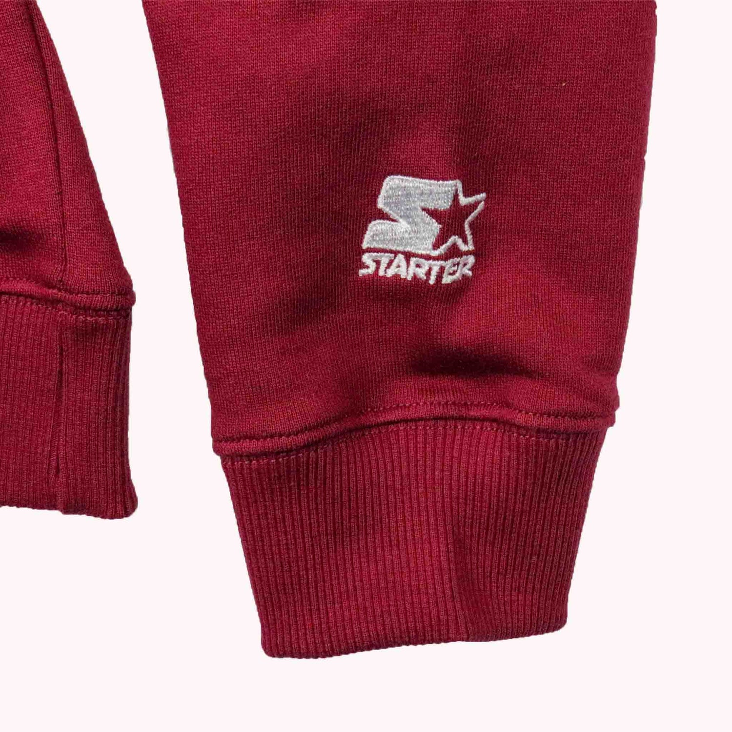 Red sweatpants with Starter logo on a white background
