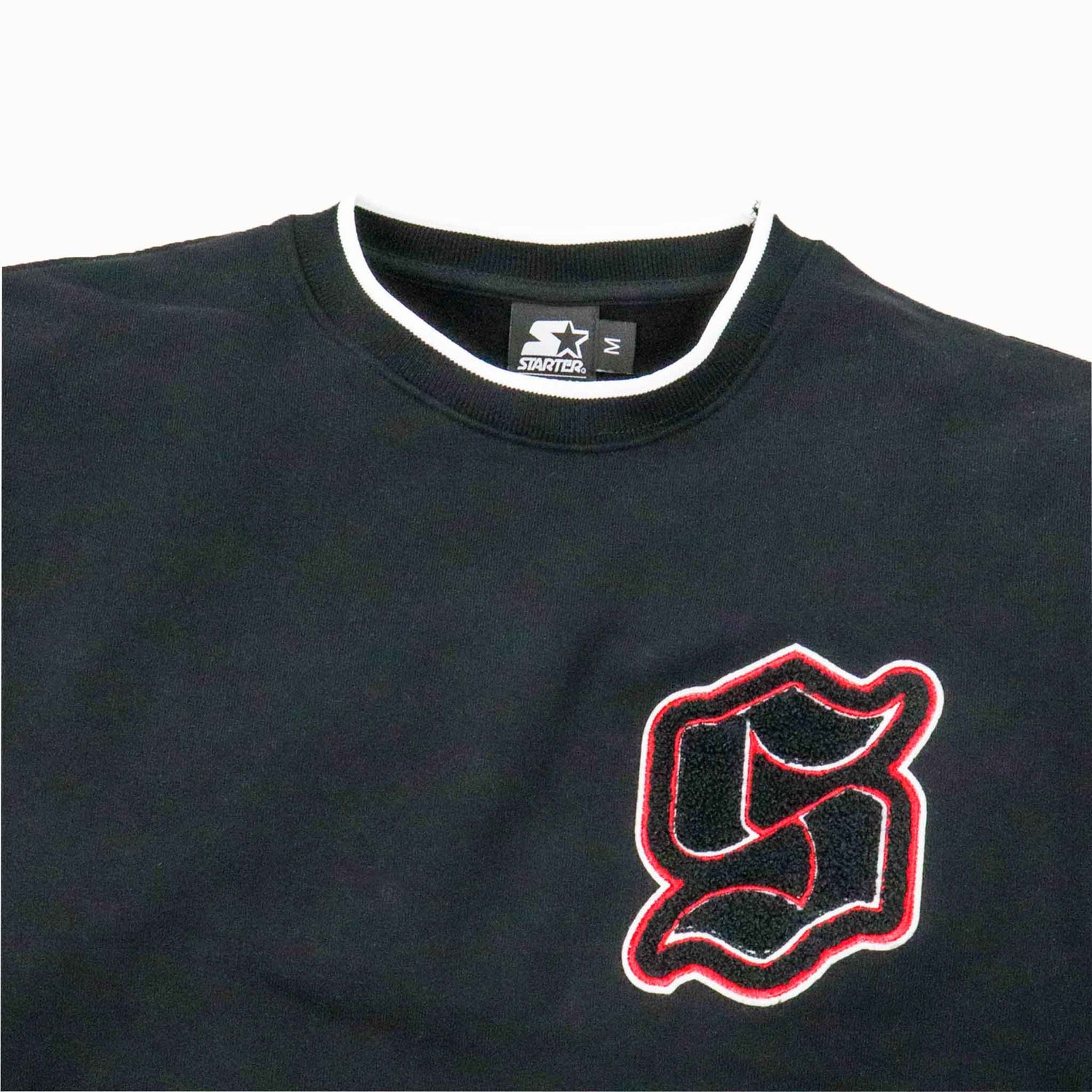 Black sweatshirt with a red and white logo on a white background