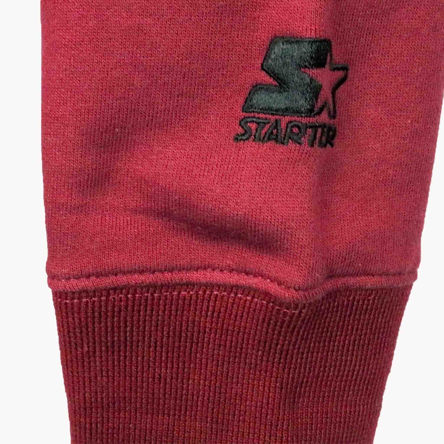 Red sweatshirt with a black logo on a white background