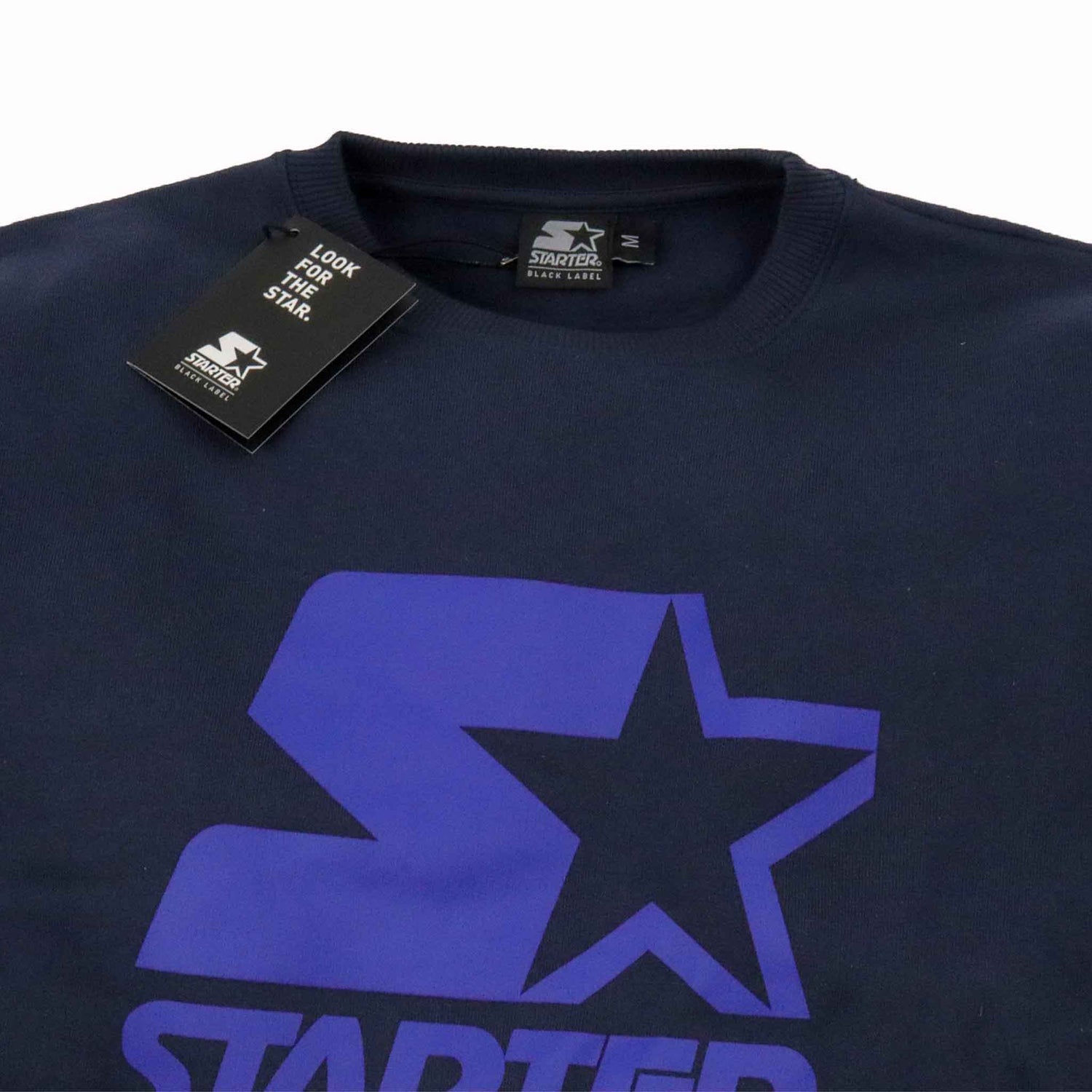 Navy blue sweatshirt with purple logo and Starter tag on a white background