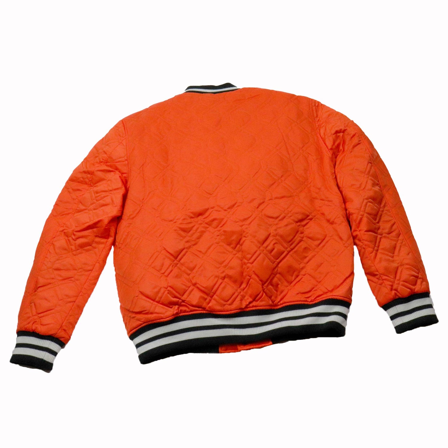 Orange quilted jacket with black and white striped cuffs on a white background