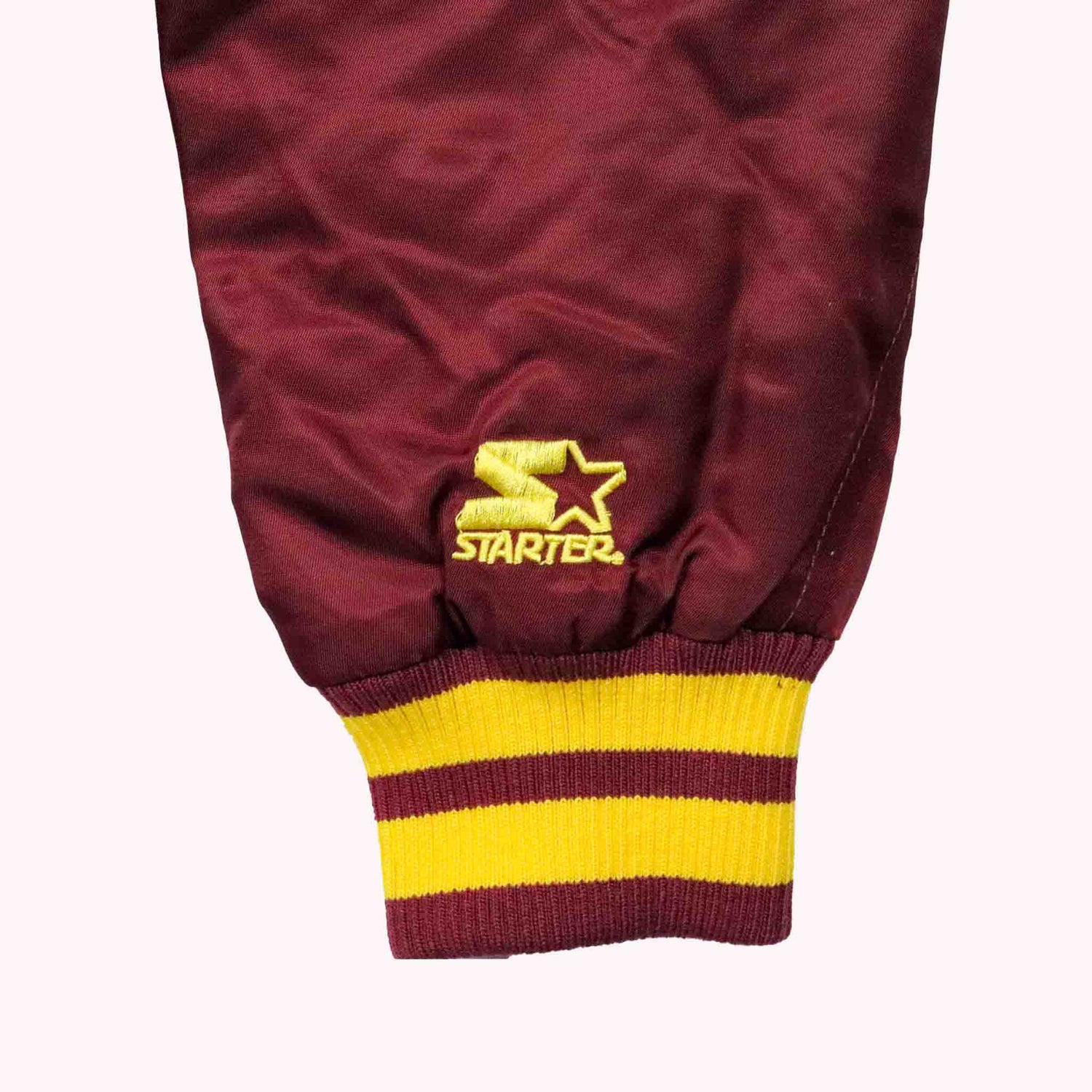 Maroon pants with yellow stripes and Starter logo on a white background