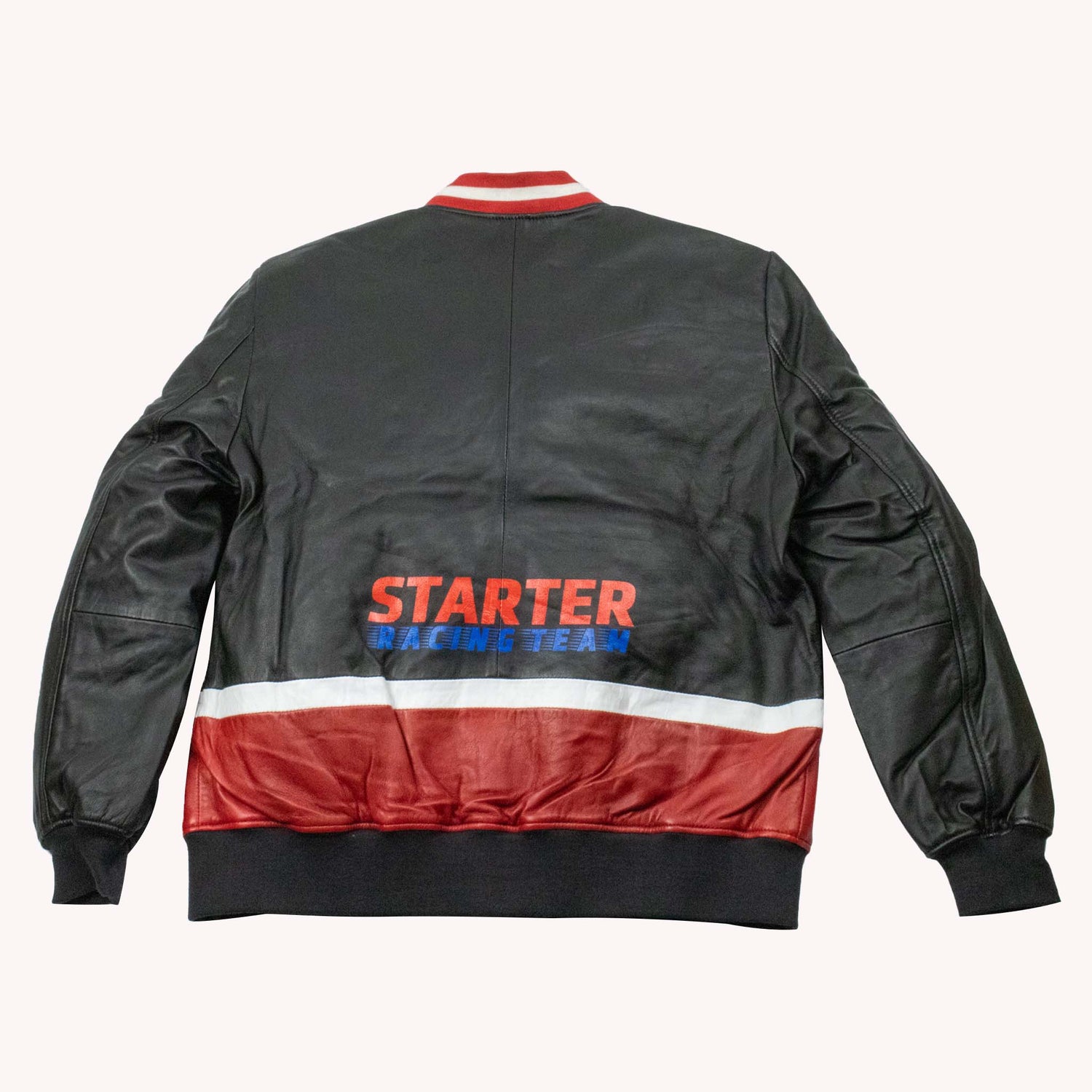 Black bomber jacket with red and white accents on a white background