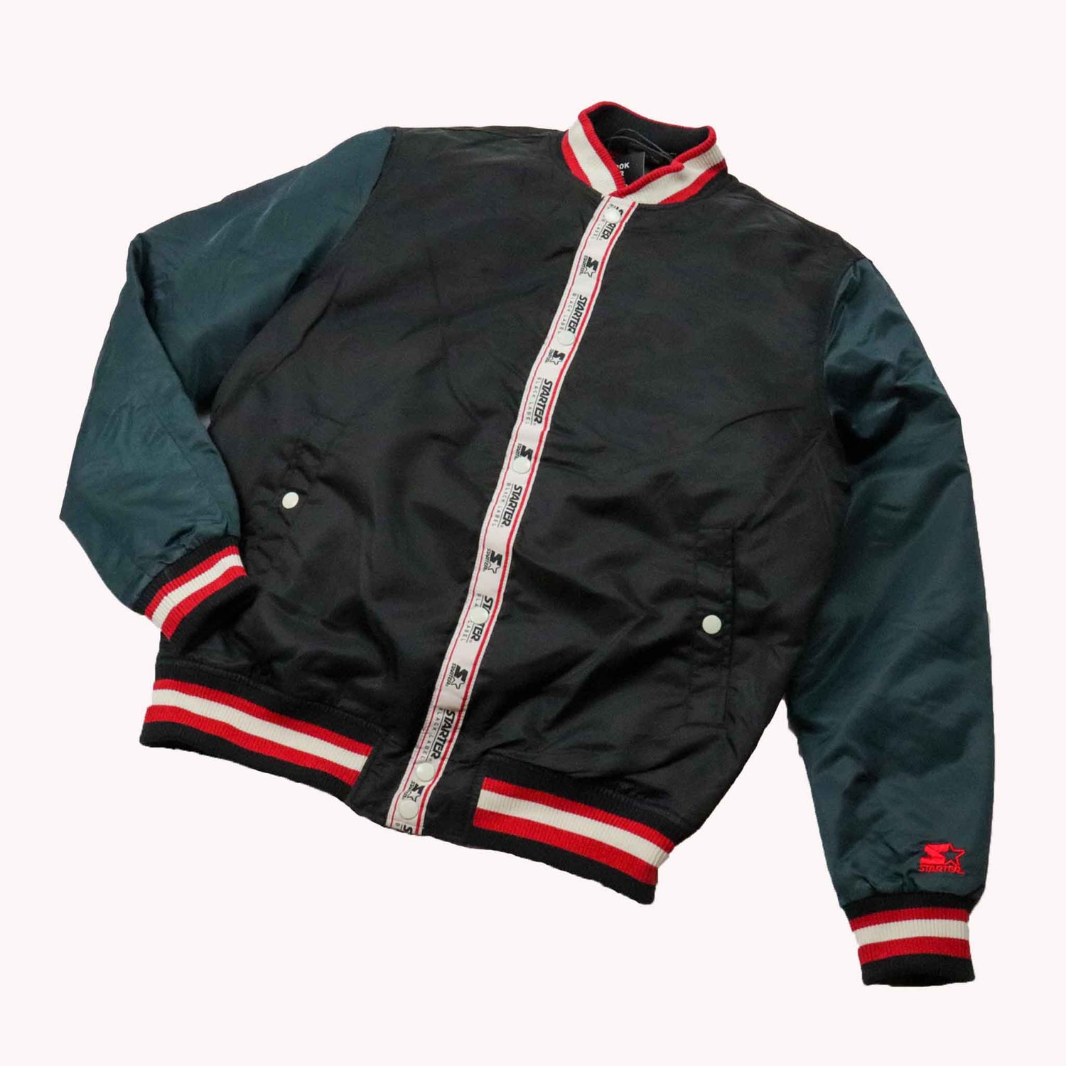 Black and green jacket with red and white accents on a white background