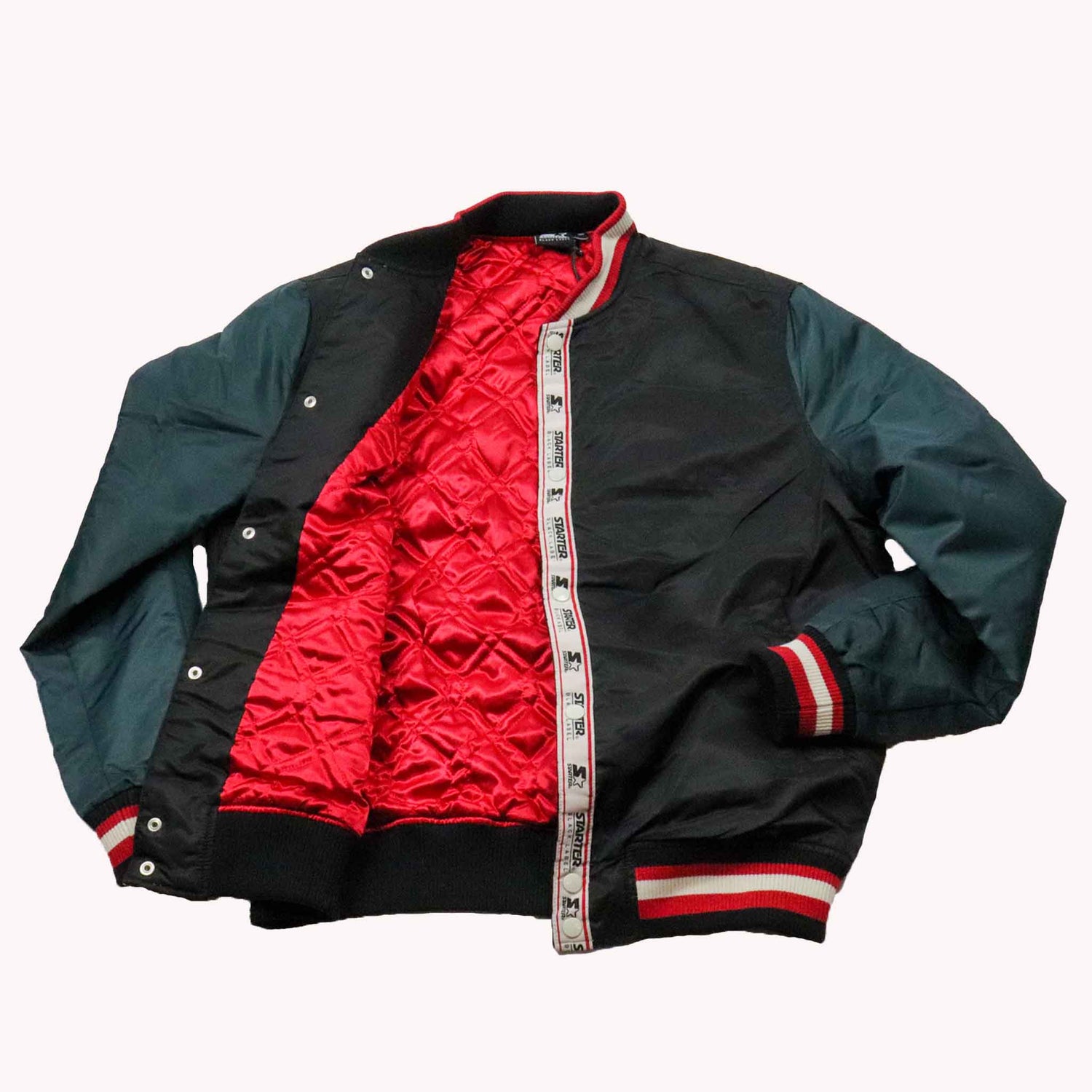 Green and black jacket with red interior on a white background
