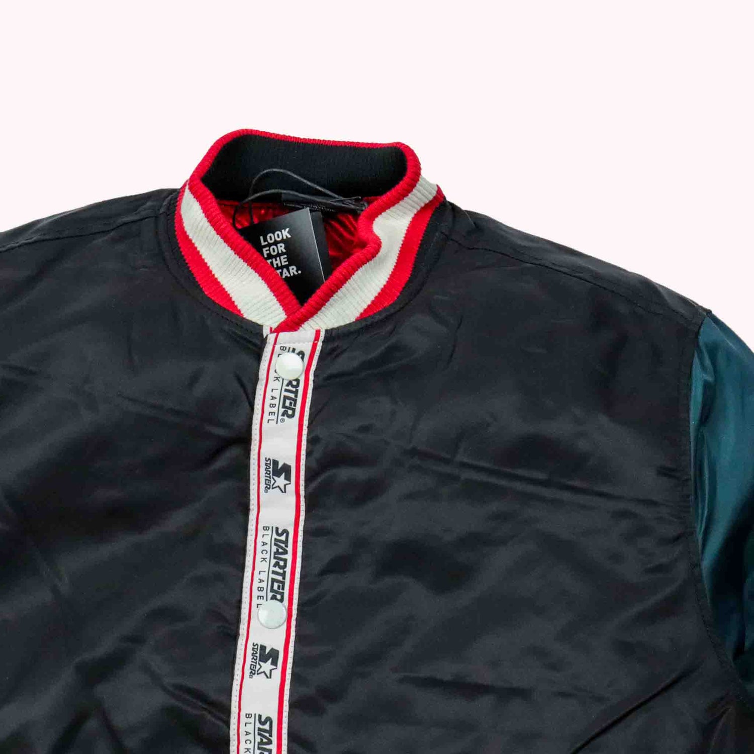 Black jacket with red interior collar and visible Starter brand on a white background