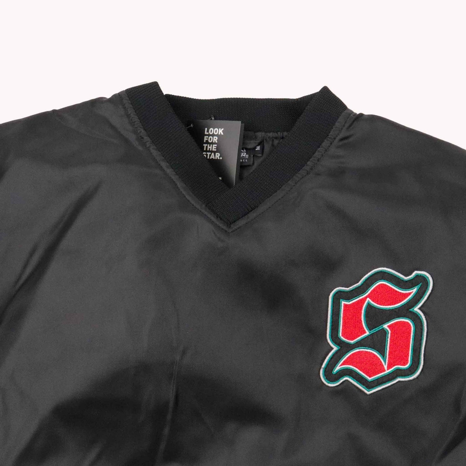 Black jacket with a red and green logo on a white background