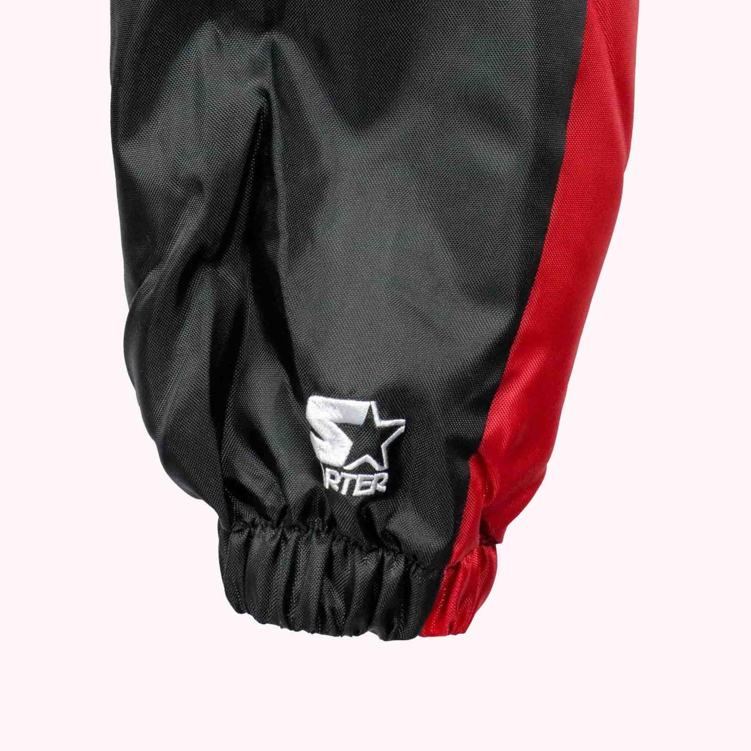 Black and red pants with a visible brand logo on a white background
