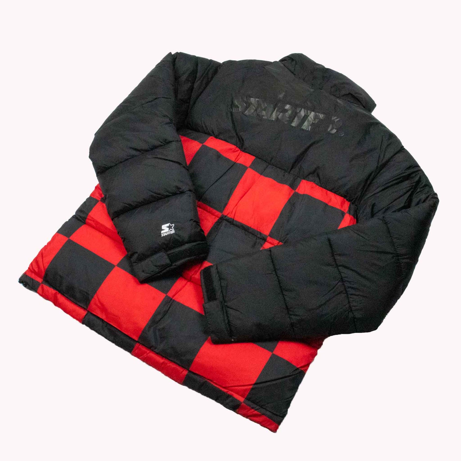 Black and red checkered puffer jacket with 'Stevie' branding on a white background