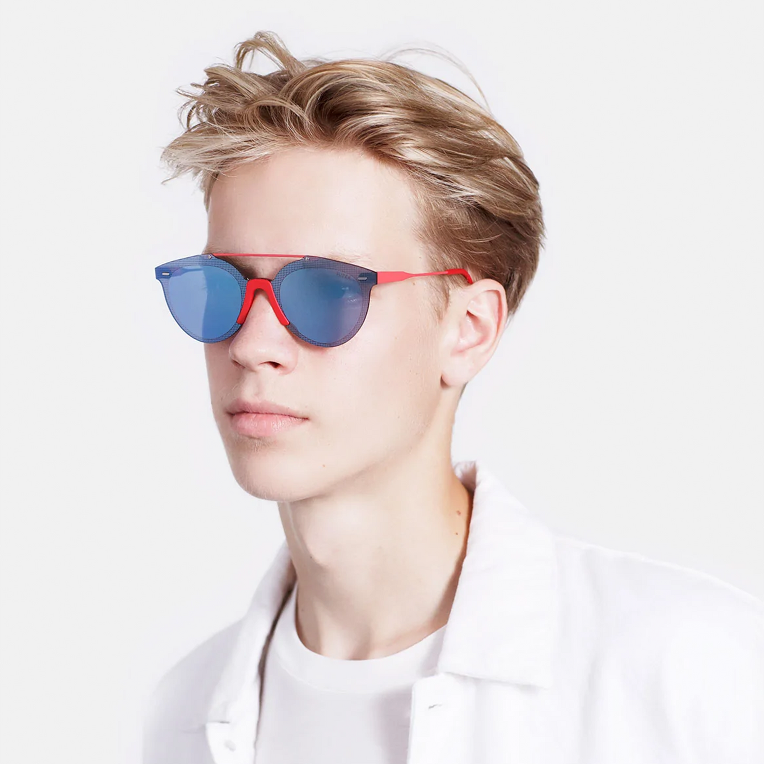 Retrosuperfuture Red and Blue sunglasses on a model wearing white T-shirt.