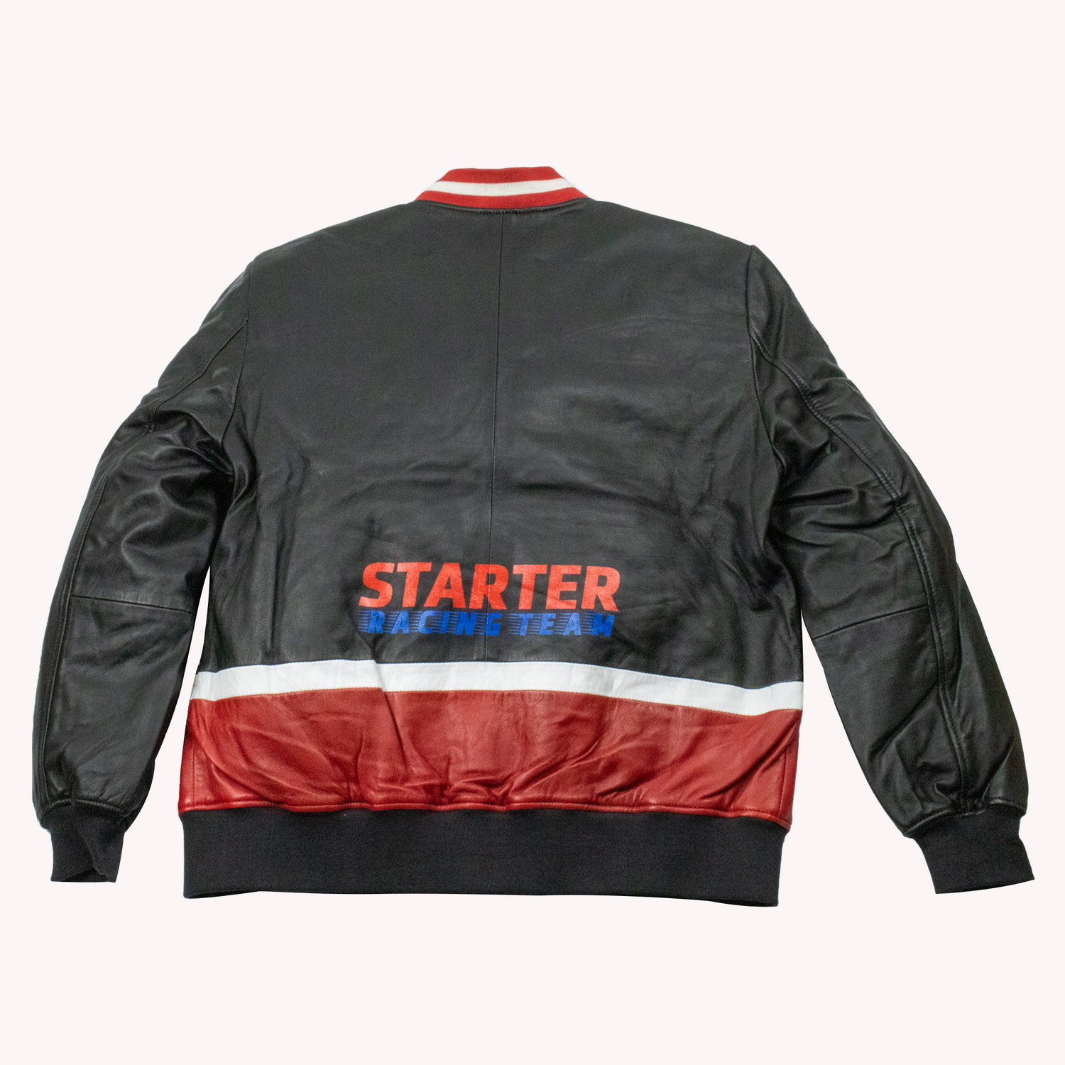 Crafted from genuine leather, this Starter Men's Black Label vintage racing jacket delivers authentic style rooted in motorsport heritage. The classic black/Red