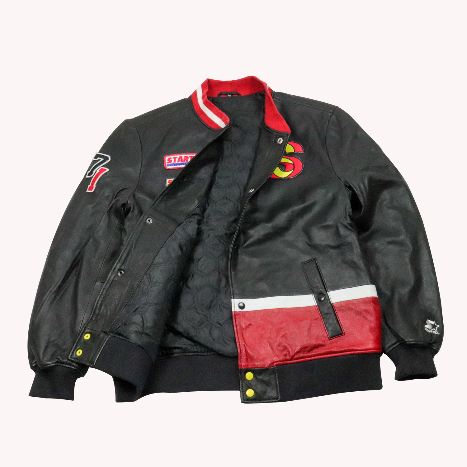 Crafted from genuine leather, this Starter Men's Black Label vintage racing jacket delivers authentic style rooted in motorsport heritage. The classic black/Red. Open Button Front View