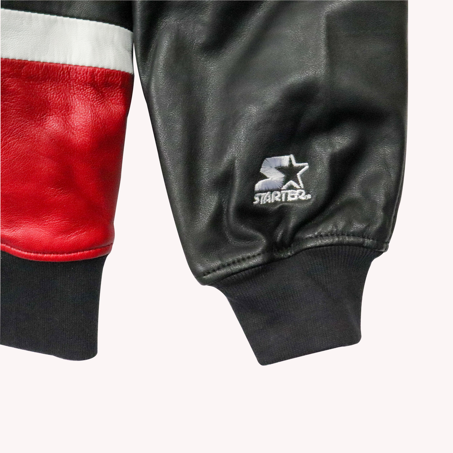 Starter Black Label Racing Leather Jackets. Real leather Sleeve Camera Close View with a White Embroidery Starter Logo.